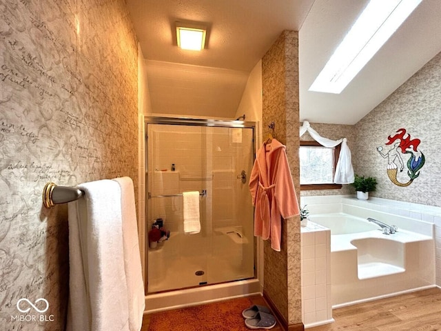 bathroom featuring a bath, a stall shower, wood finished floors, lofted ceiling, and wallpapered walls