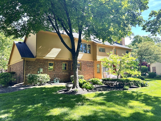 7621 Forest Dr, Fishers, IN 46038 - view of front of home with brick siding, a front yard, and a chimney