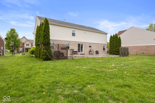 back of property featuring a yard and a patio area