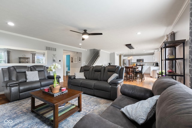 living area with visible vents, a ceiling fan, recessed lighting, and light wood-type flooring