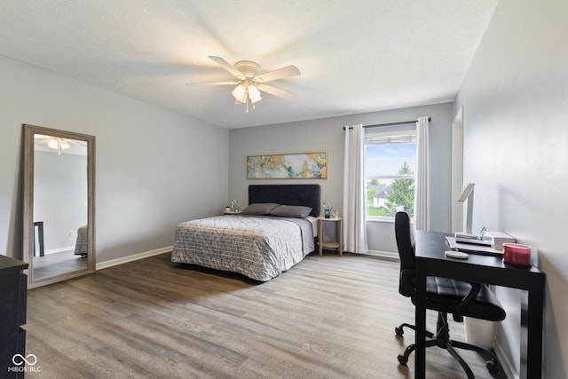 bedroom with baseboards, ceiling fan, and wood finished floors