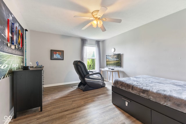 bedroom featuring baseboards, ceiling fan, and wood finished floors