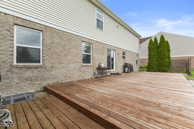 wooden terrace with a grill