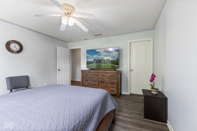 bedroom featuring dark wood-style flooring, baseboards, visible vents, and ceiling fan