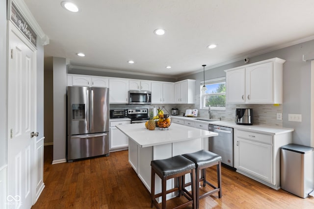kitchen featuring white cabinets, backsplash, and stainless steel appliances