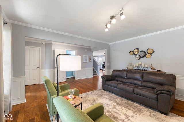 living room featuring stairway, a wainscoted wall, crown molding, and wood finished floors