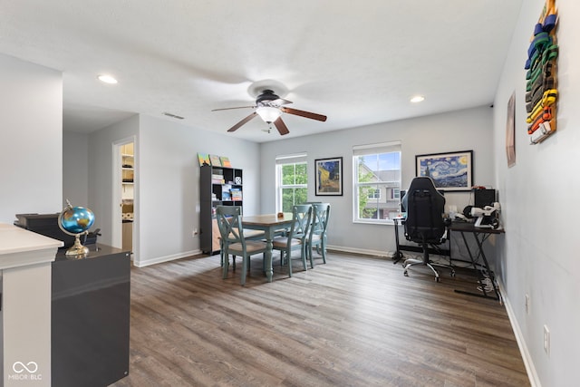 dining space featuring baseboards, ceiling fan, visible vents, and wood finished floors