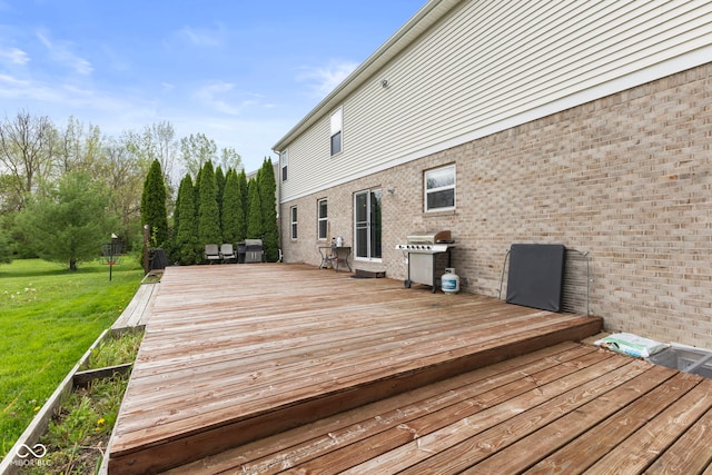 deck with a yard and area for grilling