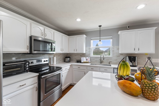 kitchen with a sink, appliances with stainless steel finishes, white cabinets, and a toaster