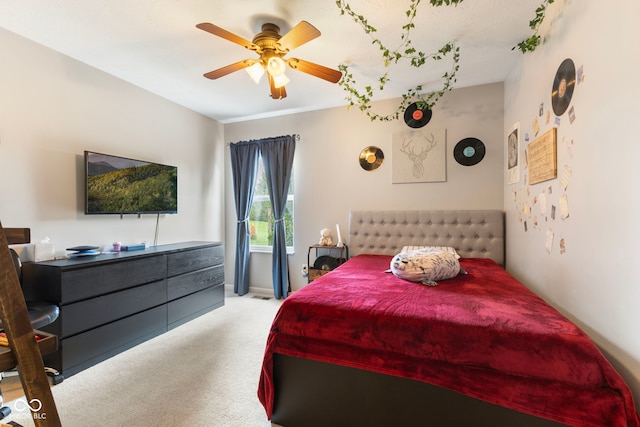 carpeted bedroom featuring baseboards and ceiling fan