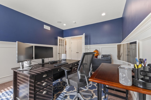 office area with wainscoting, a decorative wall, recessed lighting, and visible vents