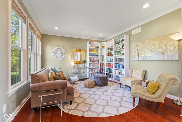 living area featuring crown molding, recessed lighting, baseboards, wood finished floors, and visible vents