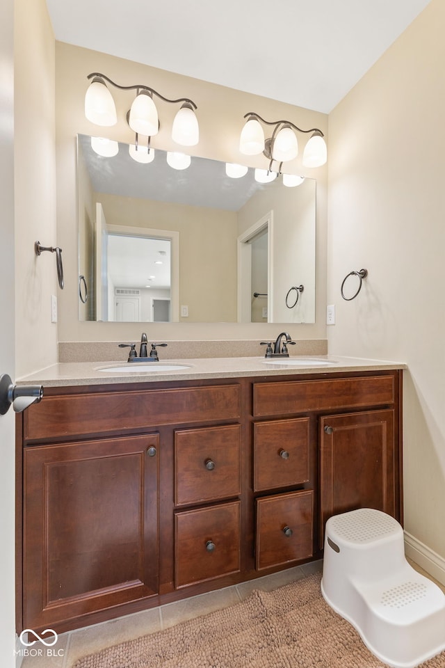 bathroom featuring double vanity, a sink, and tile patterned flooring