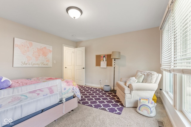 carpeted bedroom featuring baseboards, multiple windows, and visible vents
