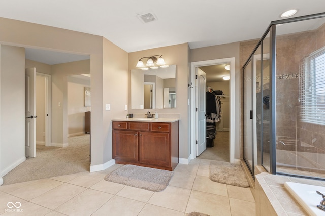 full bathroom with vanity, baseboards, a shower stall, a spacious closet, and visible vents