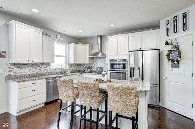 14584 Hinton Dr, Fishers, IN 46037 - kitchen with wall chimney exhaust hood, appliances with stainless steel finishes, a sink, dark wood-style flooring, and recessed lighting