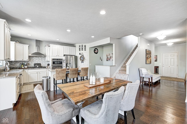 14584 Hinton Dr, Fishers, IN 46037 - dining space with dark wood finished floors, stairway, a textured ceiling, and recessed lighting