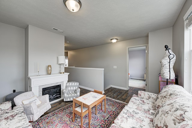 14584 Hinton Dr, Fishers, IN 46037 - living area with dark wood finished floors, baseboards, a high end fireplace, and a textured ceiling