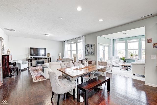14584 Hinton Dr, Fishers, IN 46037 - dining area with healthy amount of natural light, dark wood-style flooring, a textured ceiling, and recessed lighting