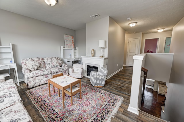 14584 Hinton Dr, Fishers, IN 46037 - living area with wood finished floors, a premium fireplace, baseboards, and a textured ceiling