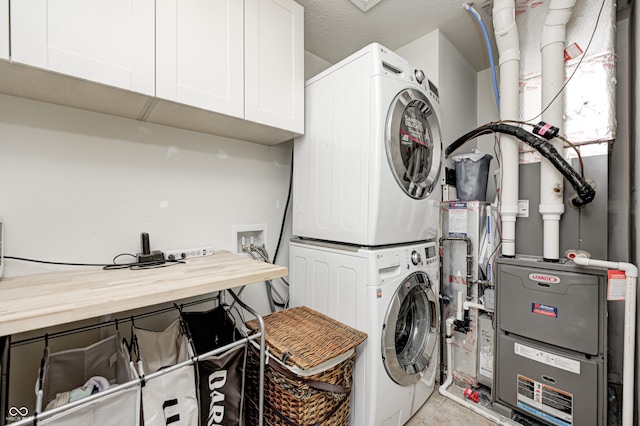 14584 Hinton Dr, Fishers, IN 46037 - laundry room featuring cabinet space and stacked washer and clothes dryer