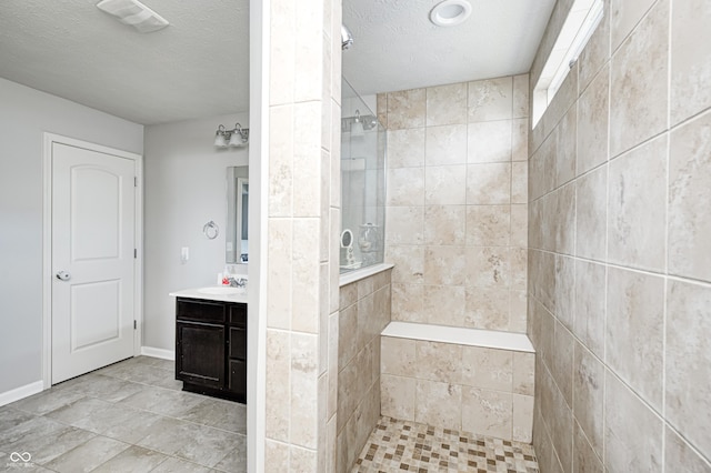 14584 Hinton Dr, Fishers, IN 46037 - bathroom with walk in shower, vanity, a textured ceiling, and tile patterned flooring