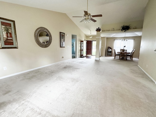 living room featuring baseboards, carpet, ceiling fan with notable chandelier, and lofted ceiling