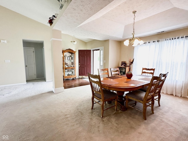 dining space featuring a textured ceiling, visible vents, baseboards, a chandelier, and light carpet