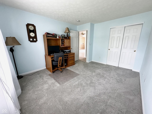 home office featuring carpet floors, a textured ceiling, and baseboards