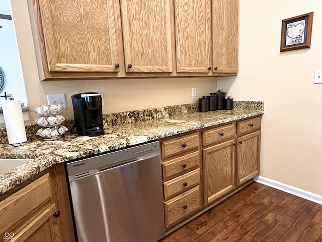kitchen featuring baseboards, light stone counters, dark wood-style floors, and dishwasher