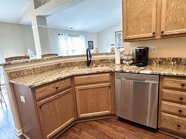 kitchen featuring stainless steel dishwasher, light stone countertops, a sink, a peninsula, and dark wood-type flooring