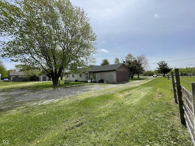 view of yard featuring an outbuilding and a storage shed