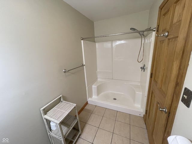 full bathroom featuring a shower, baseboards, and tile patterned floors