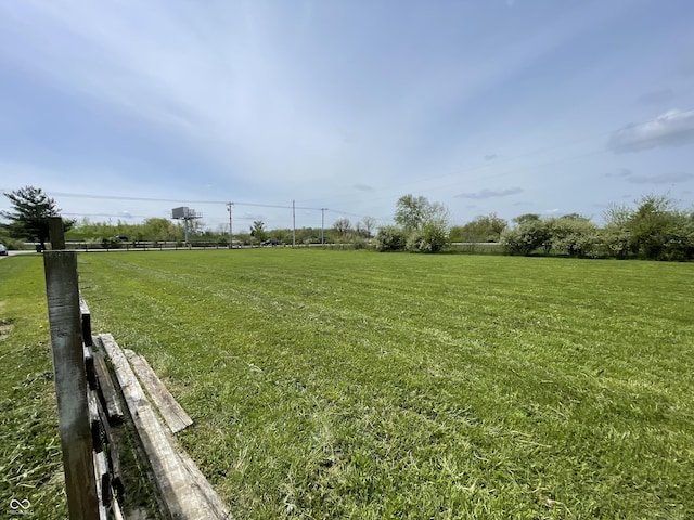 view of yard featuring a rural view and fence