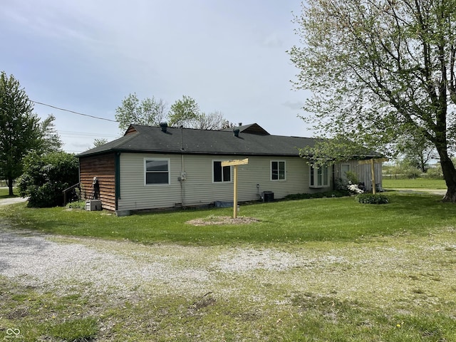 rear view of house with a yard and cooling unit