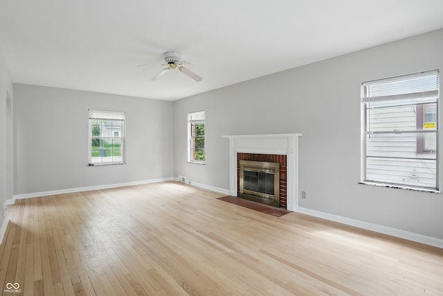 4730 Rookwood Ave, Indianapolis, IN 46208 - unfurnished living room featuring a ceiling fan, baseboards, light wood finished floors, and a fireplace