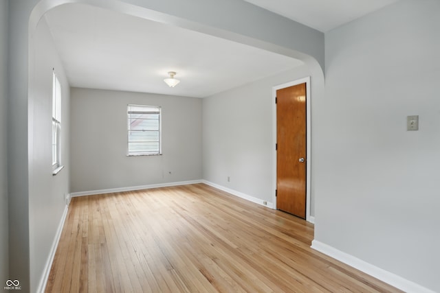 4730 Rookwood Ave, Indianapolis, IN 46208 - unfurnished room with baseboards, light wood-type flooring, and arched walkways