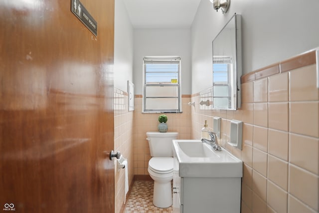 4730 Rookwood Ave, Indianapolis, IN 46208 - bathroom with vanity, wainscoting, toilet, and tile walls