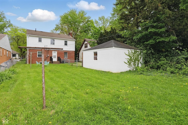 4730 Rookwood Ave, Indianapolis, IN 46208 - rear view of house with fence, a chimney, a yard, and brick siding
