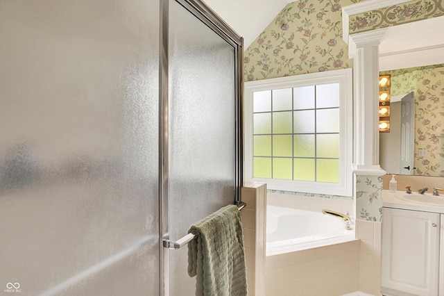 bathroom with a garden tub, a shower stall, vanity, lofted ceiling, and wallpapered walls