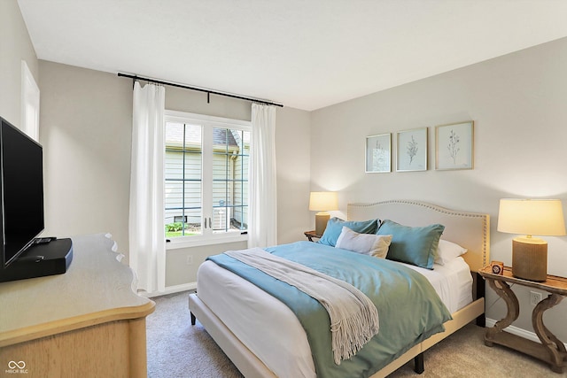 carpeted bedroom featuring baseboards