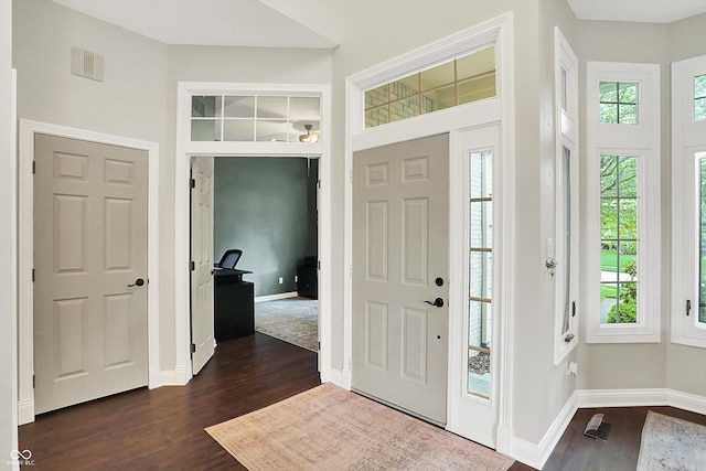 entryway with visible vents, dark wood finished floors, and baseboards