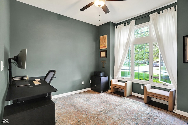 office area with baseboards and a ceiling fan