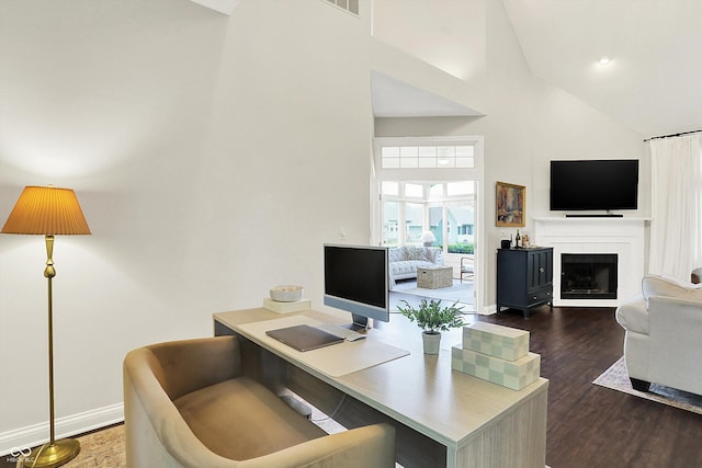 home office with high vaulted ceiling, baseboards, a fireplace, and dark wood finished floors