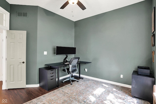 office space with baseboards, a ceiling fan, wood finished floors, and visible vents