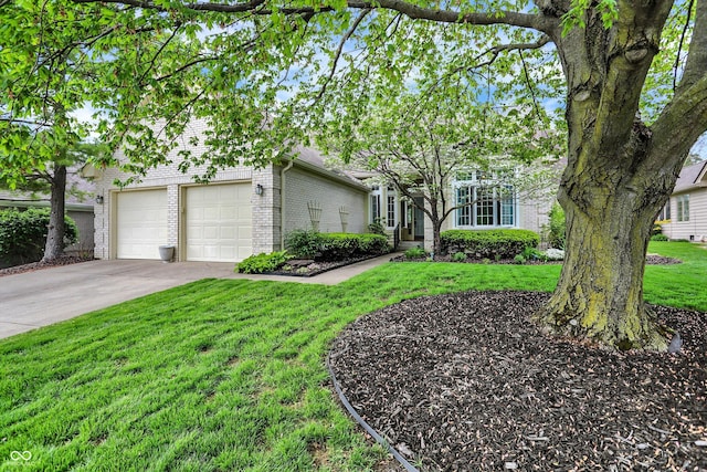 view of front of home with a garage, driveway, a front lawn, and brick siding