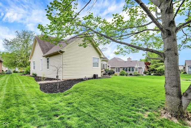 exterior space with a lawn and a shingled roof