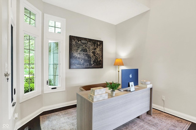 office space featuring baseboards and wood finished floors
