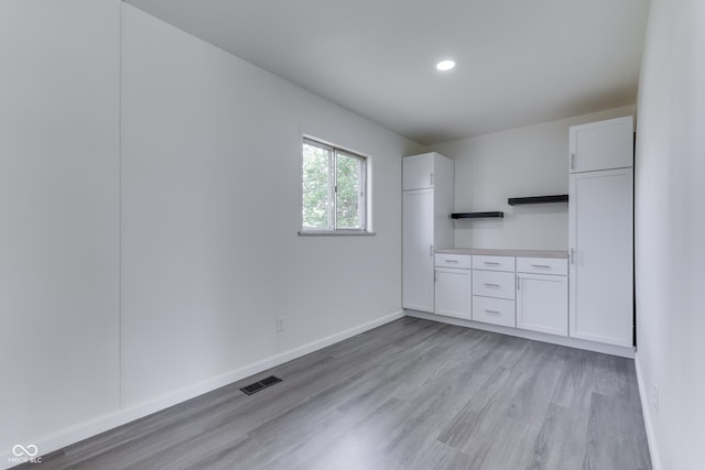 interior space with light wood-style floors, baseboards, recessed lighting, and visible vents