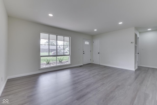 interior space featuring baseboards, recessed lighting, and wood finished floors